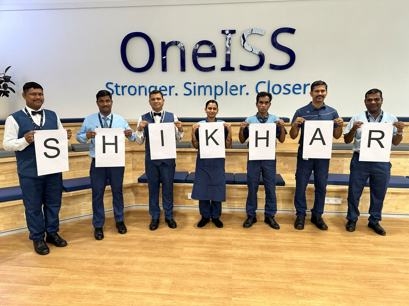 OneISS Group of people spelling out word