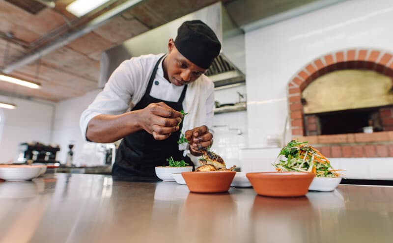 Chef cooking food at commercial kitchen