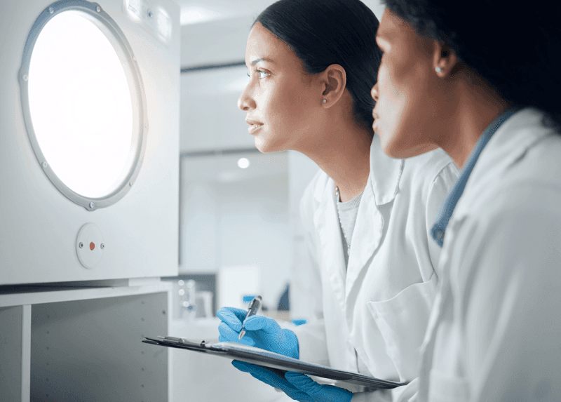 Results, experiment or people in laboratory waiting for science breakthrough, clinical trial or discovery. Door, medical exam or scientists writing checklist for DNA research, notes or development