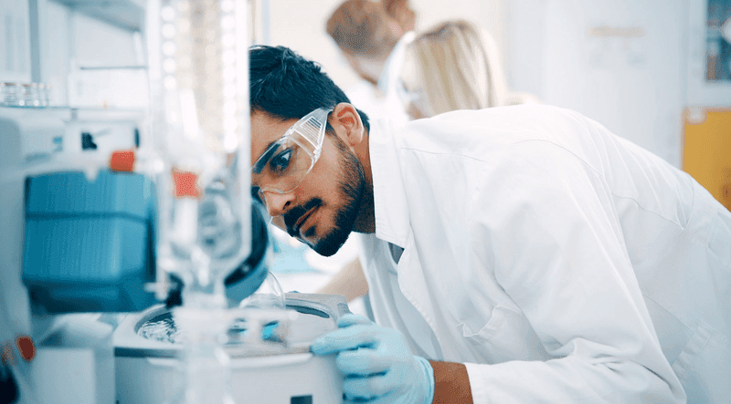 Young students of chemistry working in laboratory