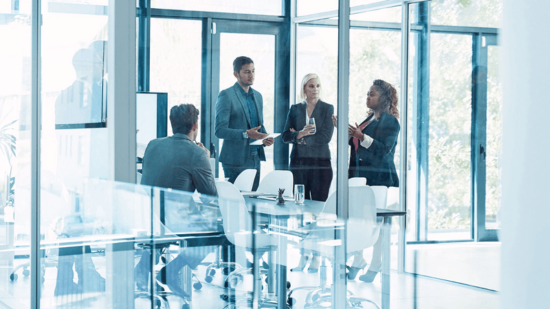 Lets delve into the details. Full length shot of a group of corporate businesspeople meeting in the boardroom.