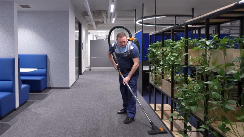 Man with backpack vacuum cleaner incl plants