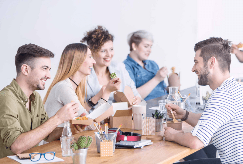 Coworkers eating lunch together