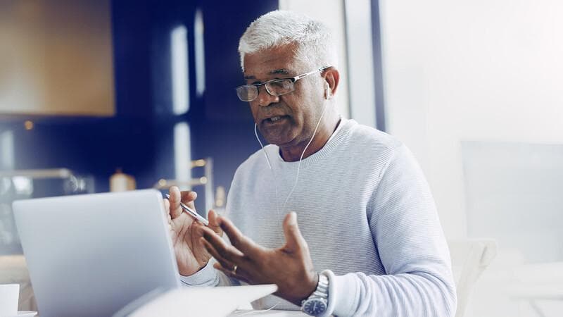 Businessman having an online meeting while working from home