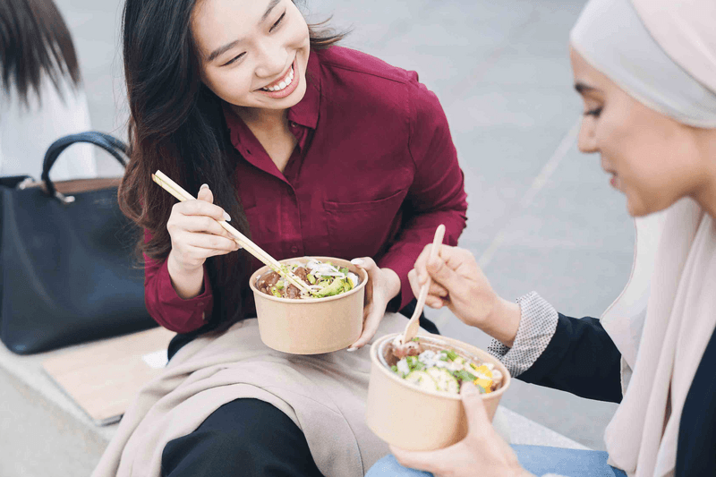 Multiracial business people doing lunch break outdoor from office building - Focus on asian woman face